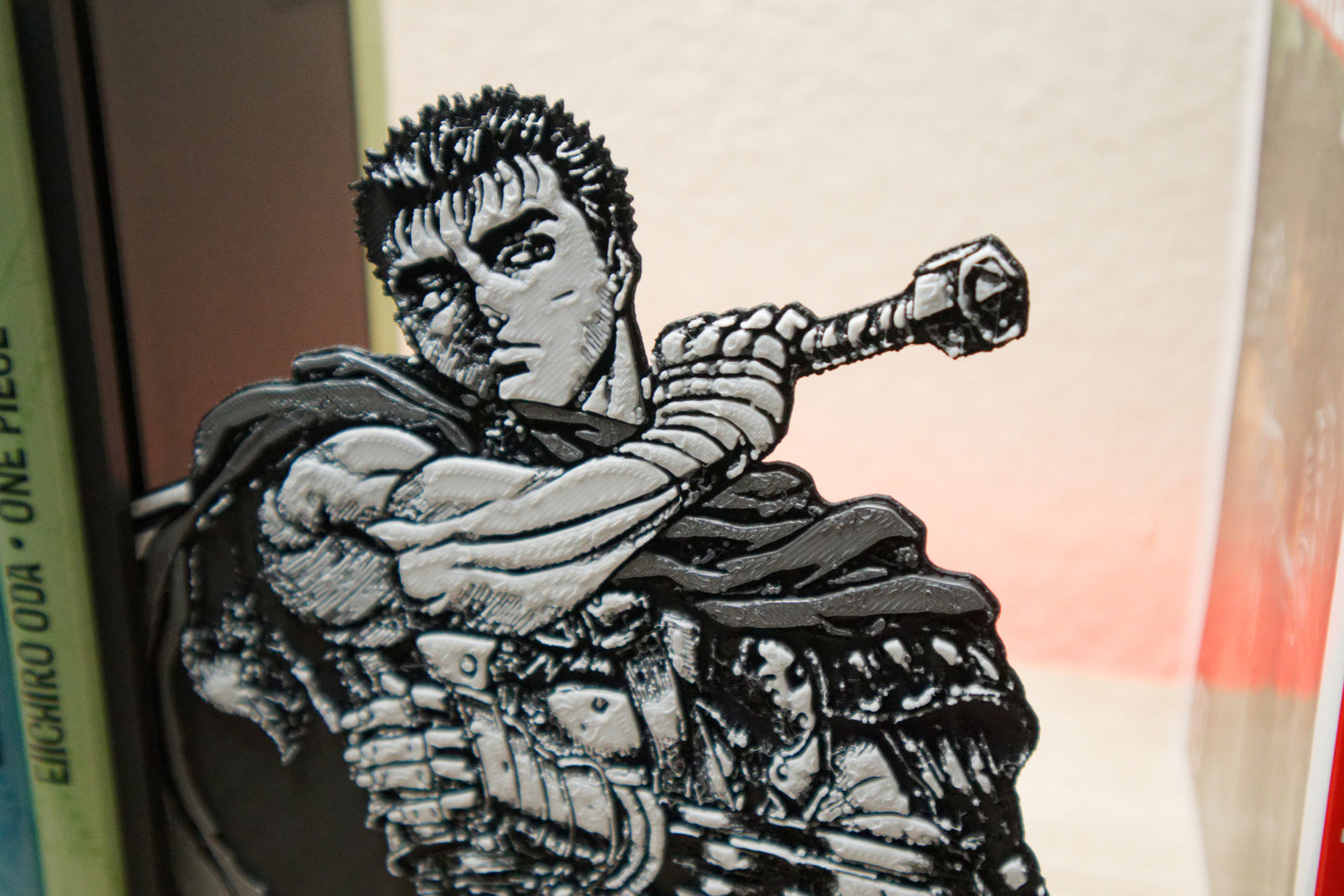 Sujetalibros de Guts de joven