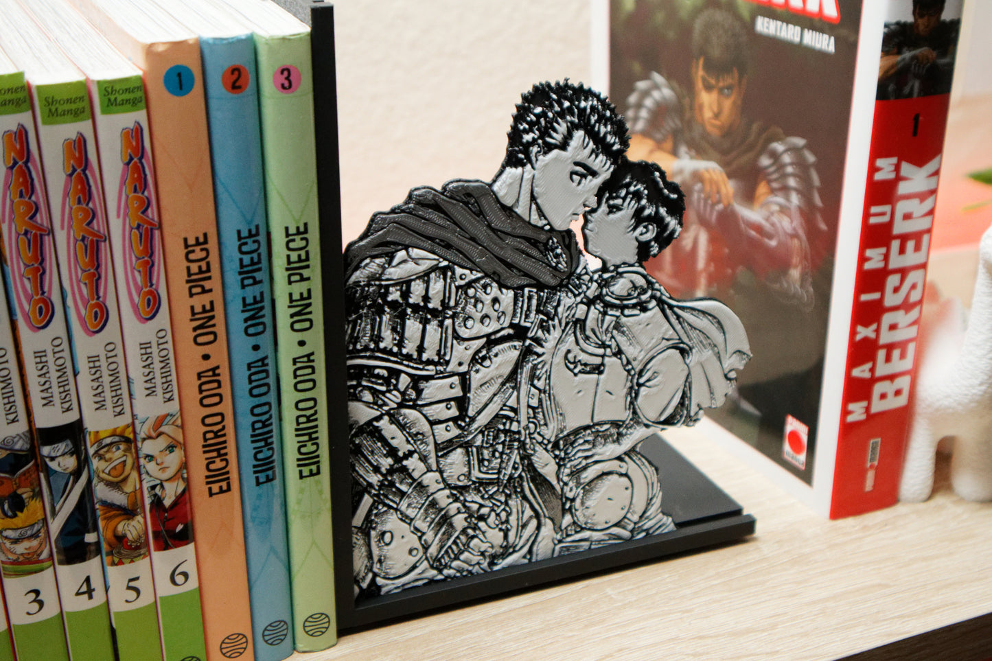 Sujetalibros de Guts y Casca